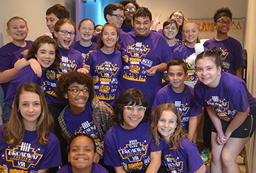 Young theatre camp attendees posing for a group photo