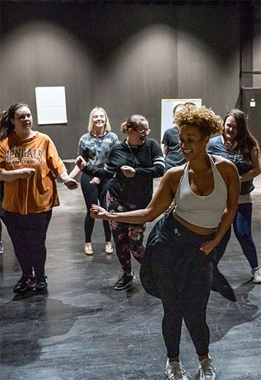 Students learn to dance from an instructor