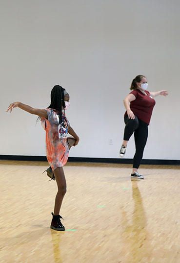 Students learn to dance from an instructor