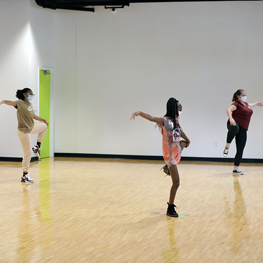 Students learn to dance from an instructor