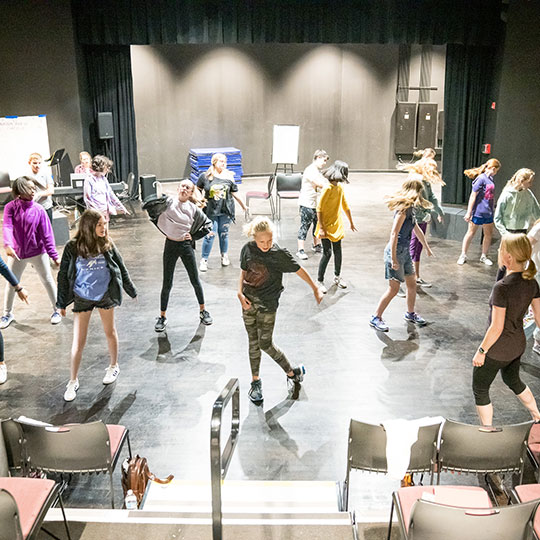 Students learn to dance from an instructor