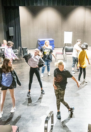 Students learn to dance from an instructor