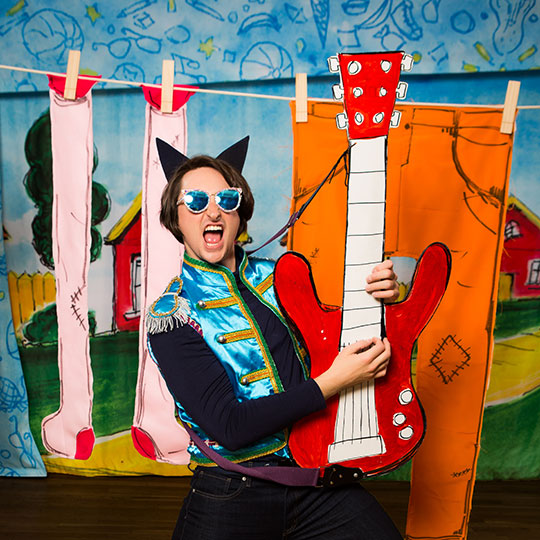 An actor portrays Pete The Cat on stage