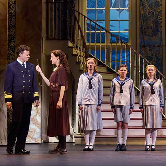 Kevin Earley (Captain Georg von Trapp) and Cayleigh Capaldi (Maria Rainer) with the von Trapp Children (l to r) Ariana Ferch (Liesl), Eli Vander Griend (Friedrich), Ava Davis (Louisa), Benjamin Stasiek (Kurt), Haddie Mac (Brigitta), Ruby Caramore (Marta), Luciana VanDette (Gretl) in THE SOUND OF MUSIC. Photo by Jeremy Daniel.